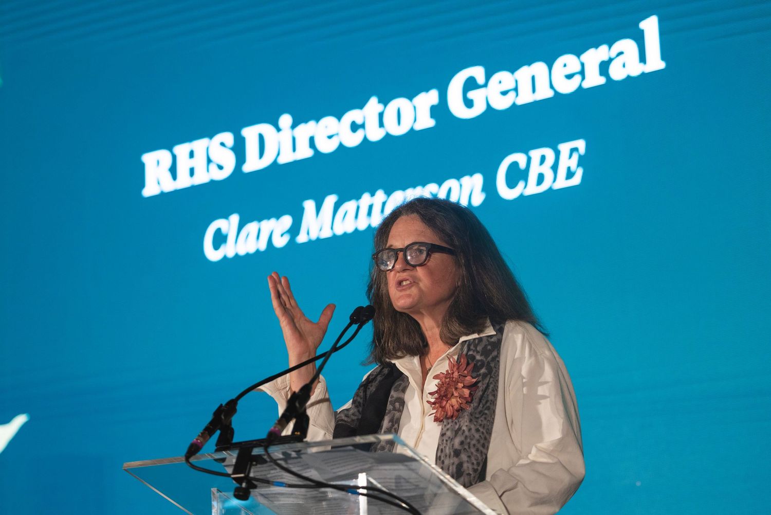 Clare Matterson CBE speaking at a podium during an RHS fundraising conference and corporate event