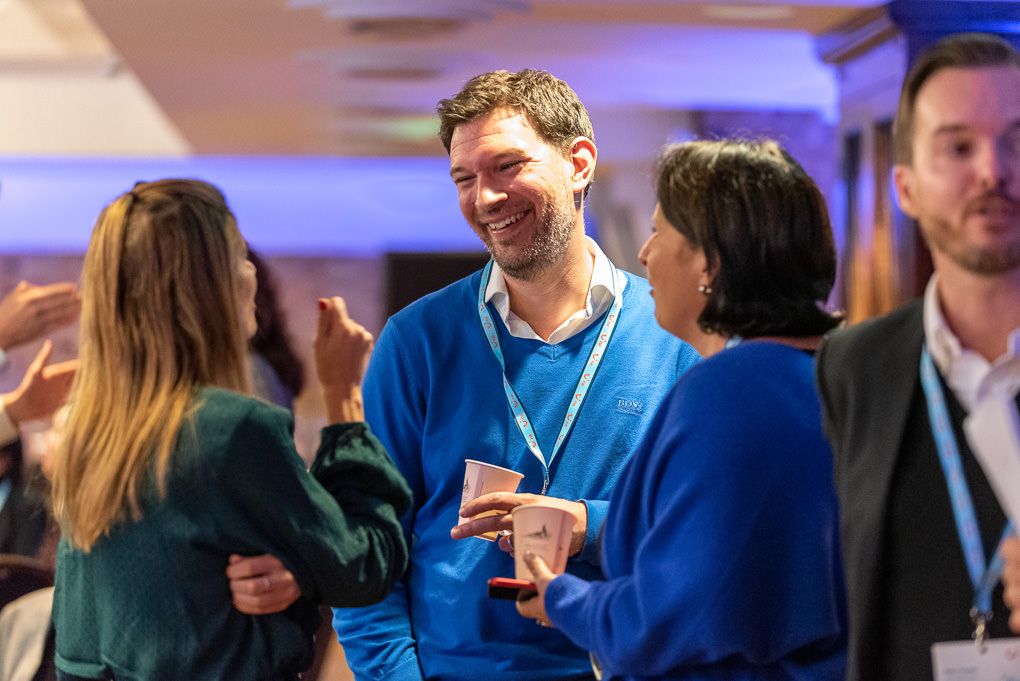 Business professionals network and socialise at a corporate conference event with drinks and conversation at The Brewery in London.