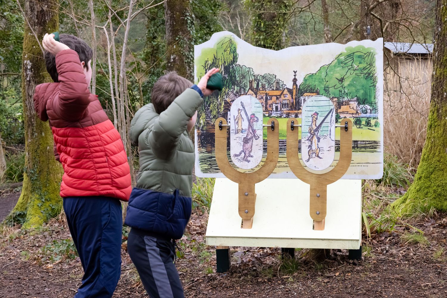 Family exploring the Wind in the Willows trail at RHS Rosemoor, photographed as lifestyle visitor attraction photography.