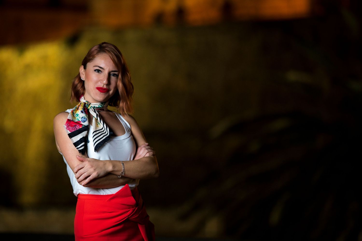 Professional portrait of confident woman standing outdoors at night, photographed for personal branding and business profile imagery.