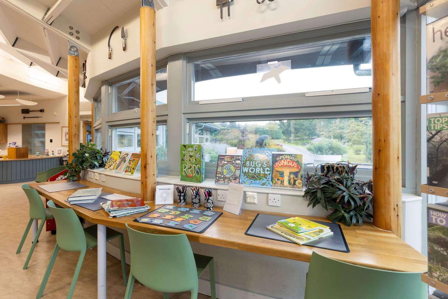 Bright children’s library reading area with colourful books, natural light and welcoming interior design.