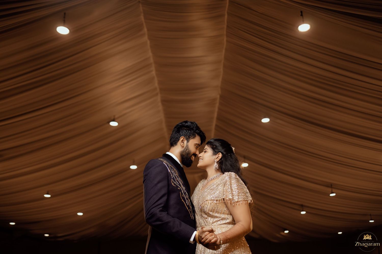 Bride and groom sharing intimate moment under draped tent, candid wedding photography, Chennai