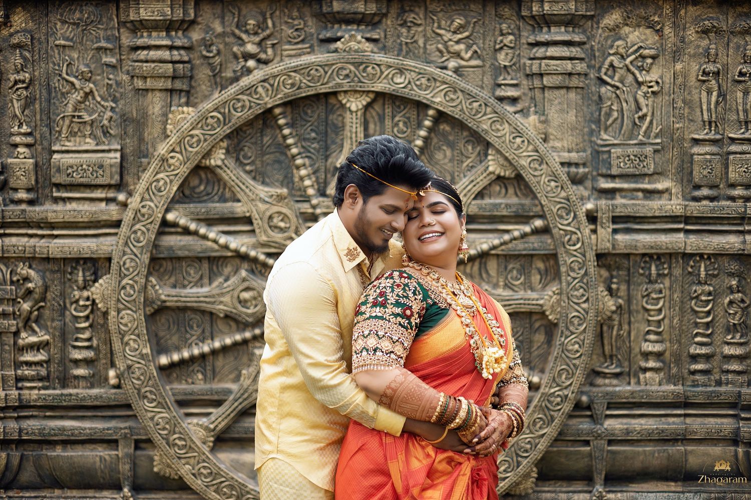 Couple portrait in traditional attire at temple sculpture during pre-wedding shoot Tamil Nadu