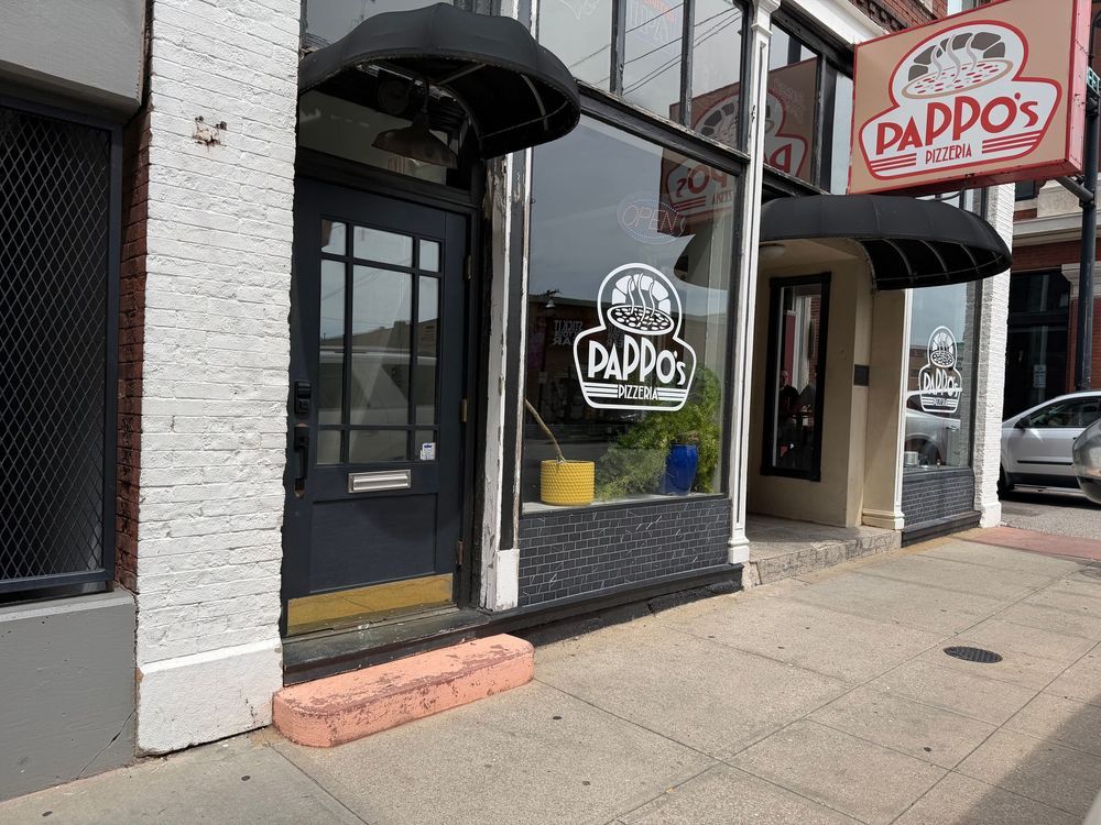 Exterior storefront of Pappo's restaurant with large window signage on a city sidewalk.