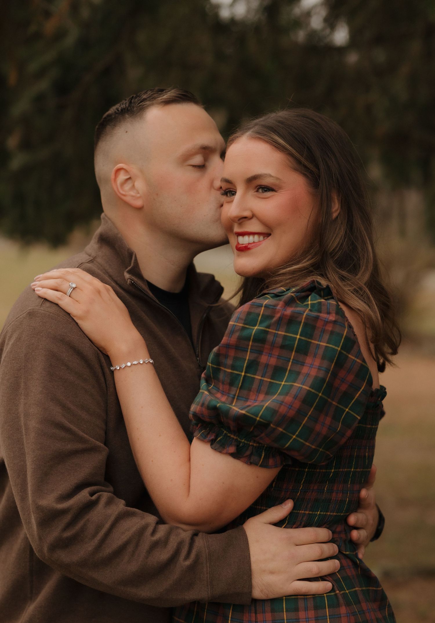 Romantic outdoor photoshoot with couple in winter attire.