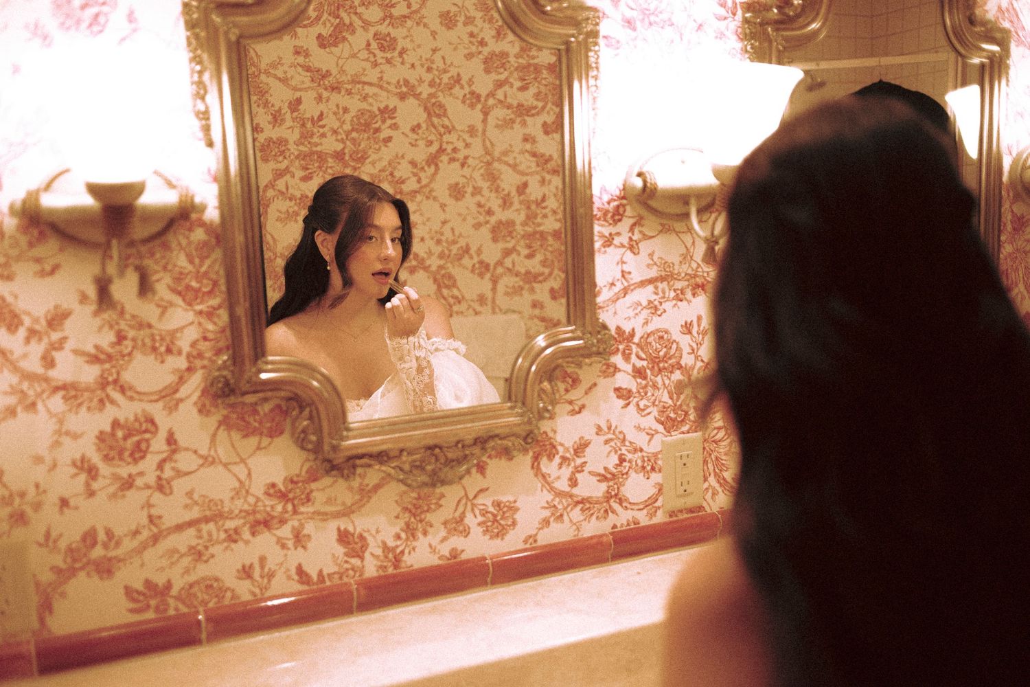 bride getting ready at Old Mill Toronto hotel deluxe king suite with vintage wall patterns