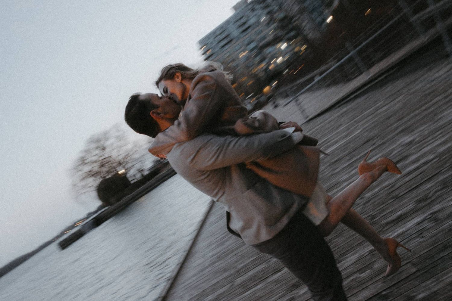 Couple kissing at Toronto waterfront after City Hall wedding — romantic and dreamy wedding portrait