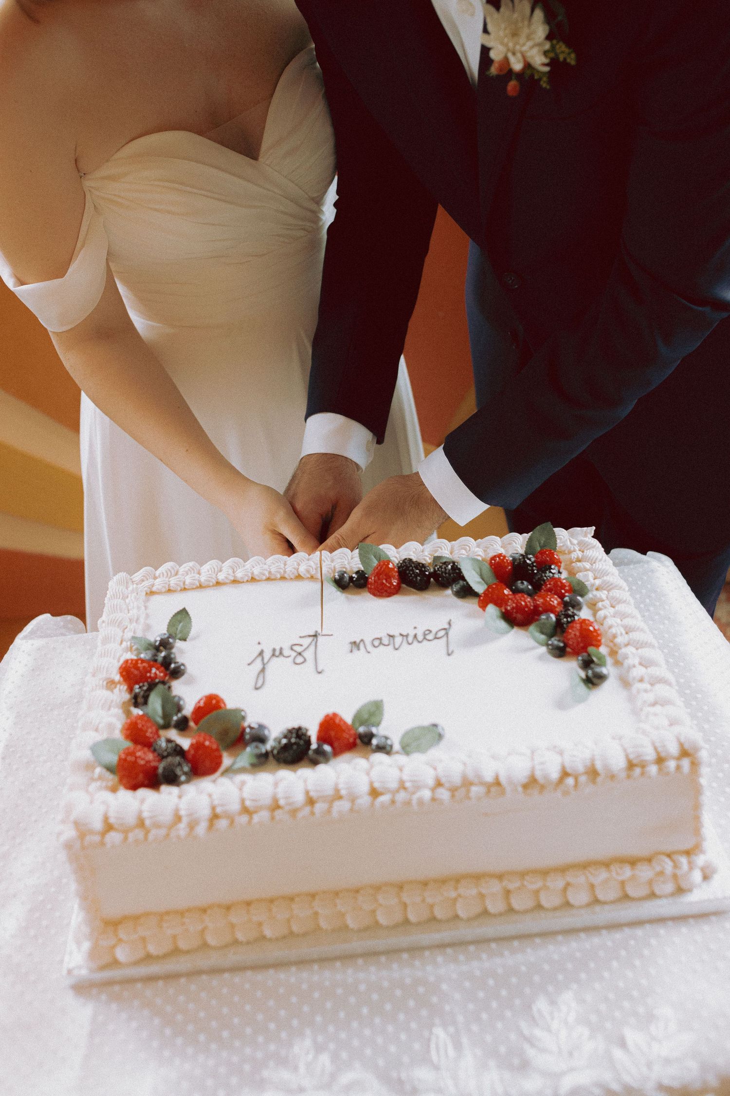 Couple cutting a “Just Married” cake at Junto Studio during an intimate Toronto wedding