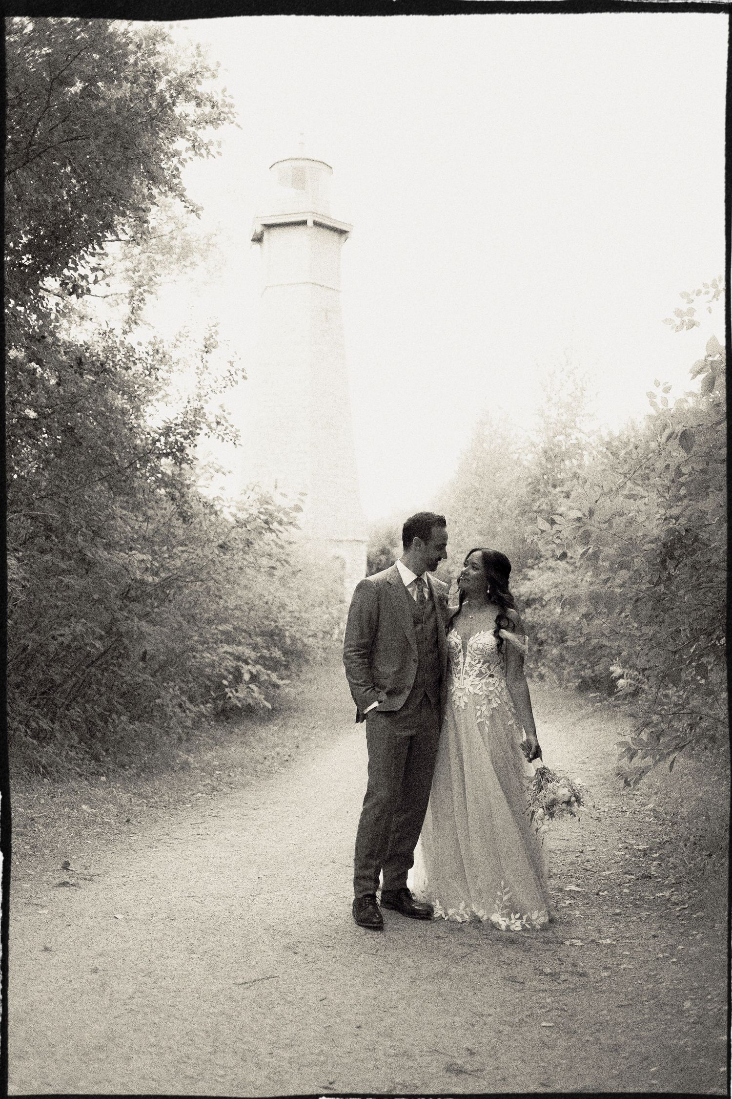 bride and groom in front of Gibraltar Point lighthouse on Toronto Island