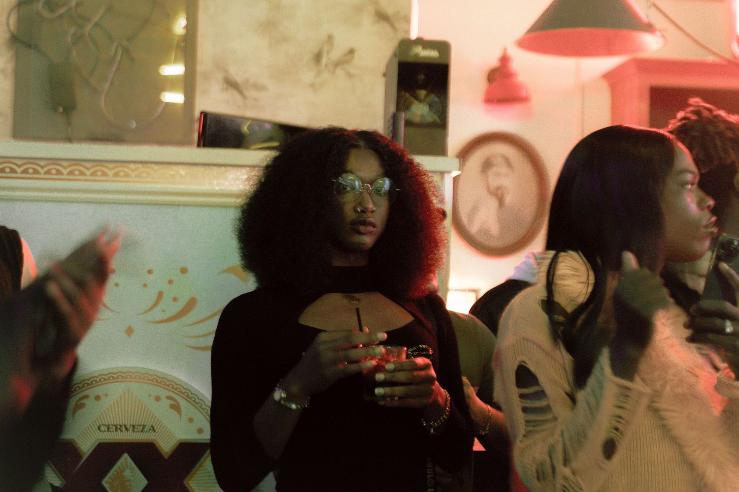 Amal, an American trans woman starring at the camera, photo taken during the 420 Ball at Hush Hush