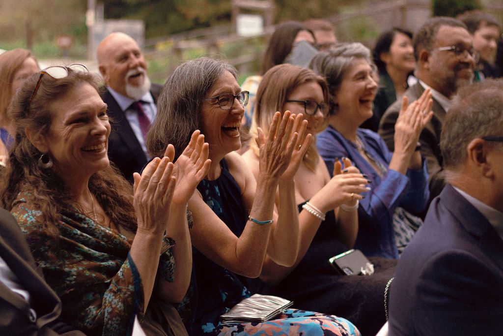 Guests cheering a same-sex couple during their summer wedding at Fantasy Farm Toronto