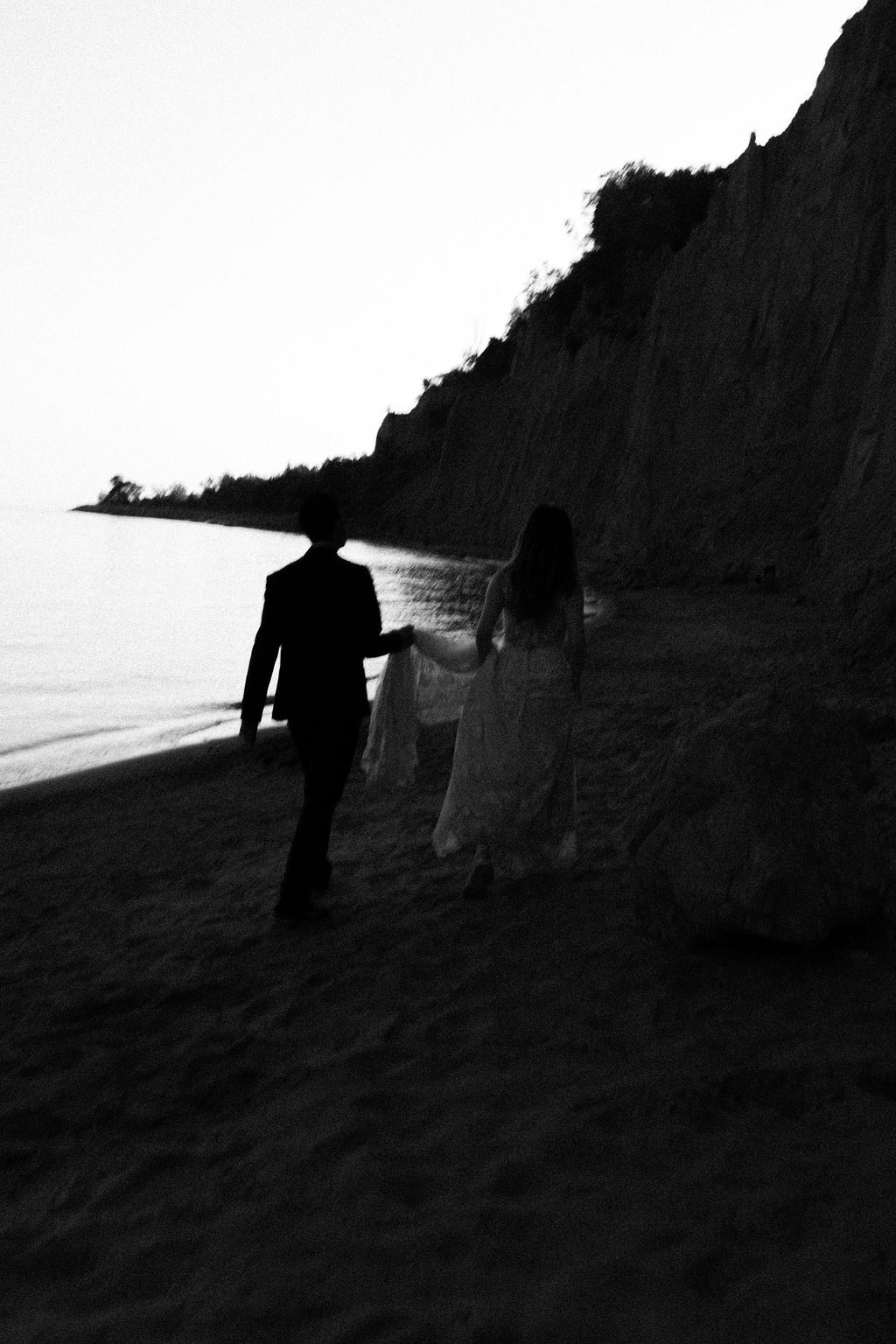 Couple walking along Scarborough Bluffs beach after sunset vows