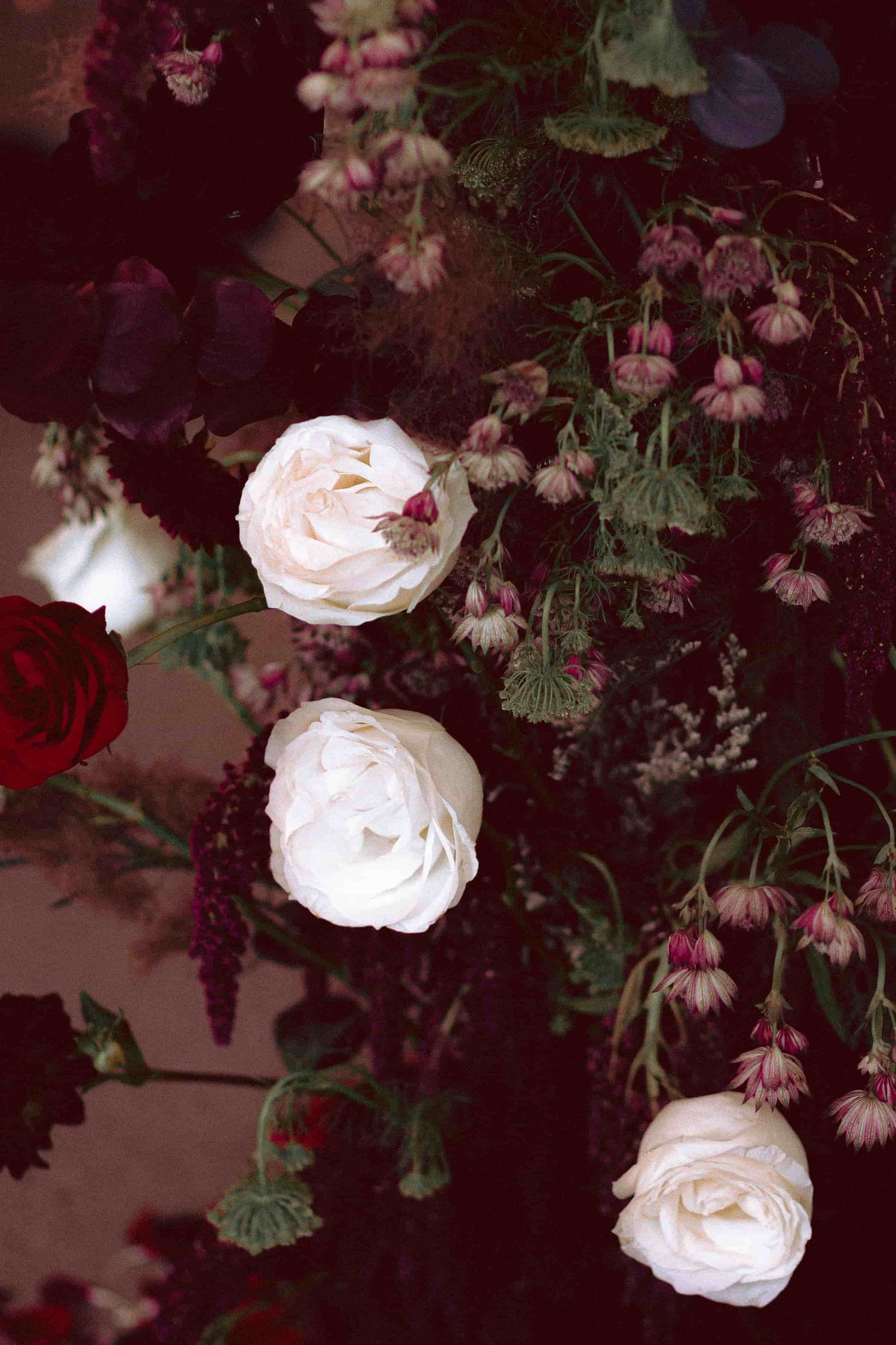 Dark and moody floral arrangement designed for an intimate wedding celebration.