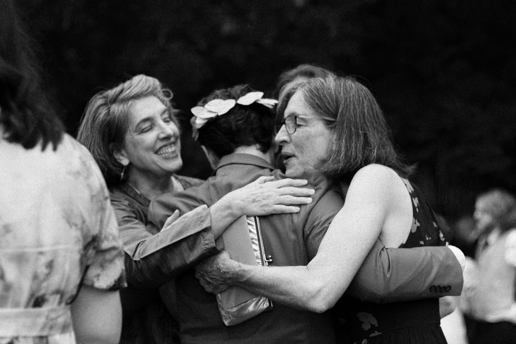 Guests cheering a same-sex couple during their summer wedding at Fantasy Farm Toronto