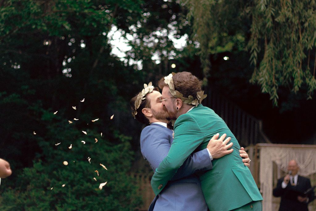 Guests tossing petals as couple exits after same-sex wedding ceremony at Fantasy Farm Toronto