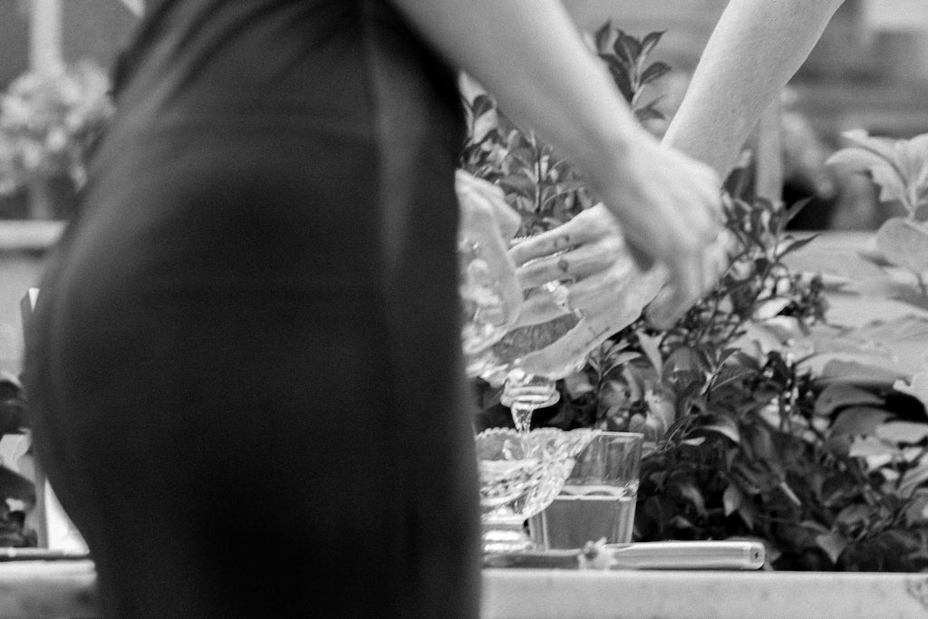 Couple pouring water simultaneously into shared vase during love ritual at Bar Neon Toronto