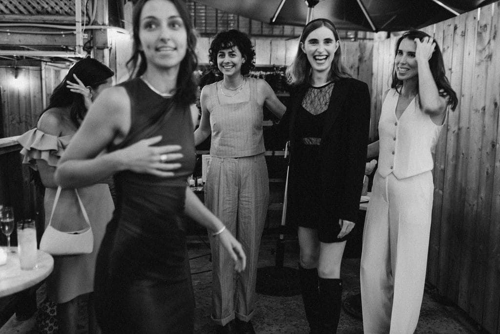 Candid celebration moment at LGBTQ+ commitment ceremony Bar Neon Toronto west end