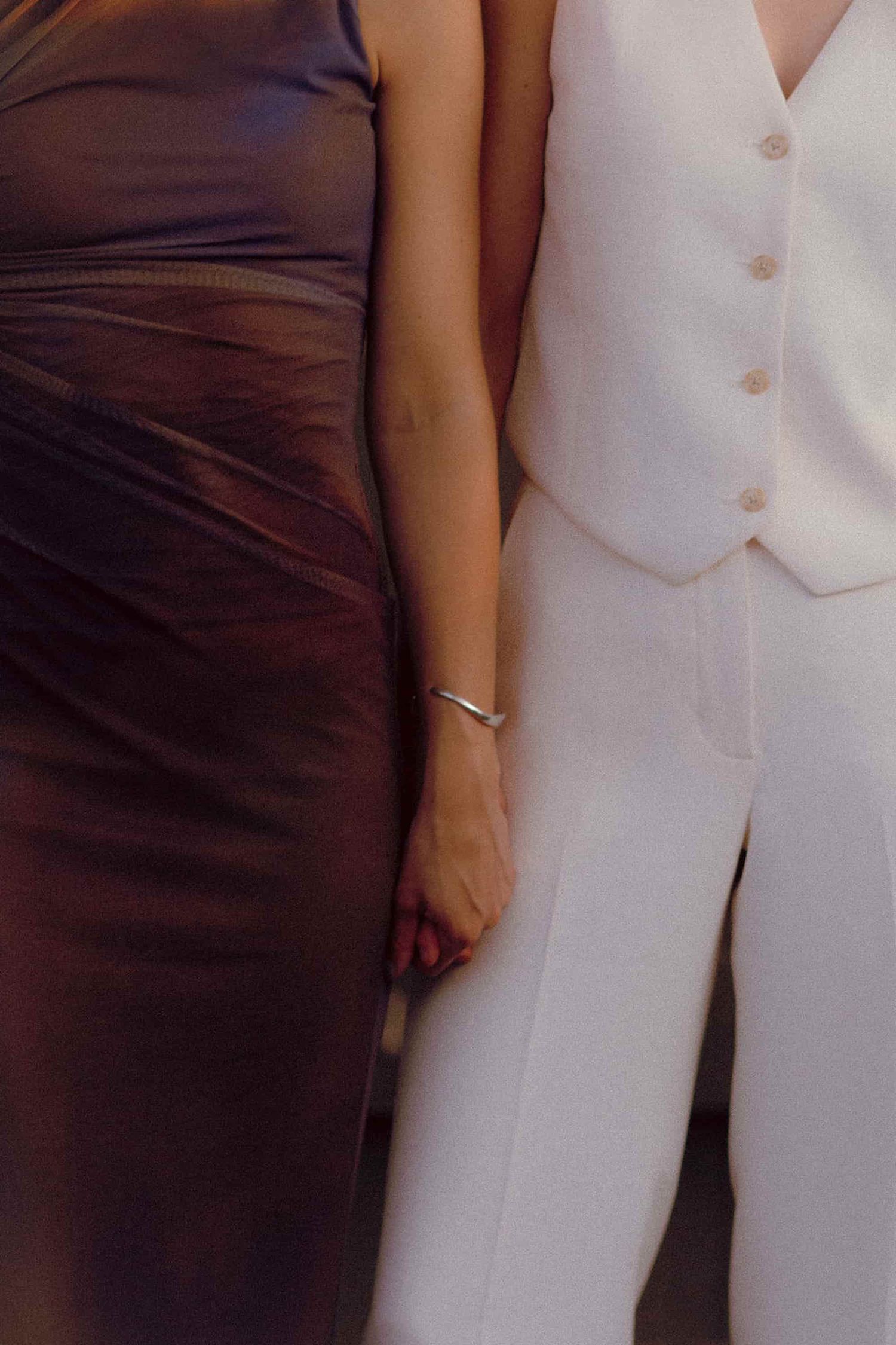 Queer couple embracing during intimate commitment ceremony at Bar Neon Toronto