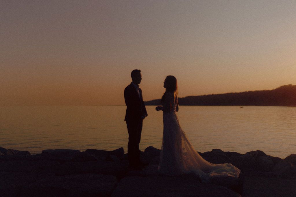 Summer Scarborough Bluffs elopement at sunset in Toronto with couple embracing by Lake Ontario
