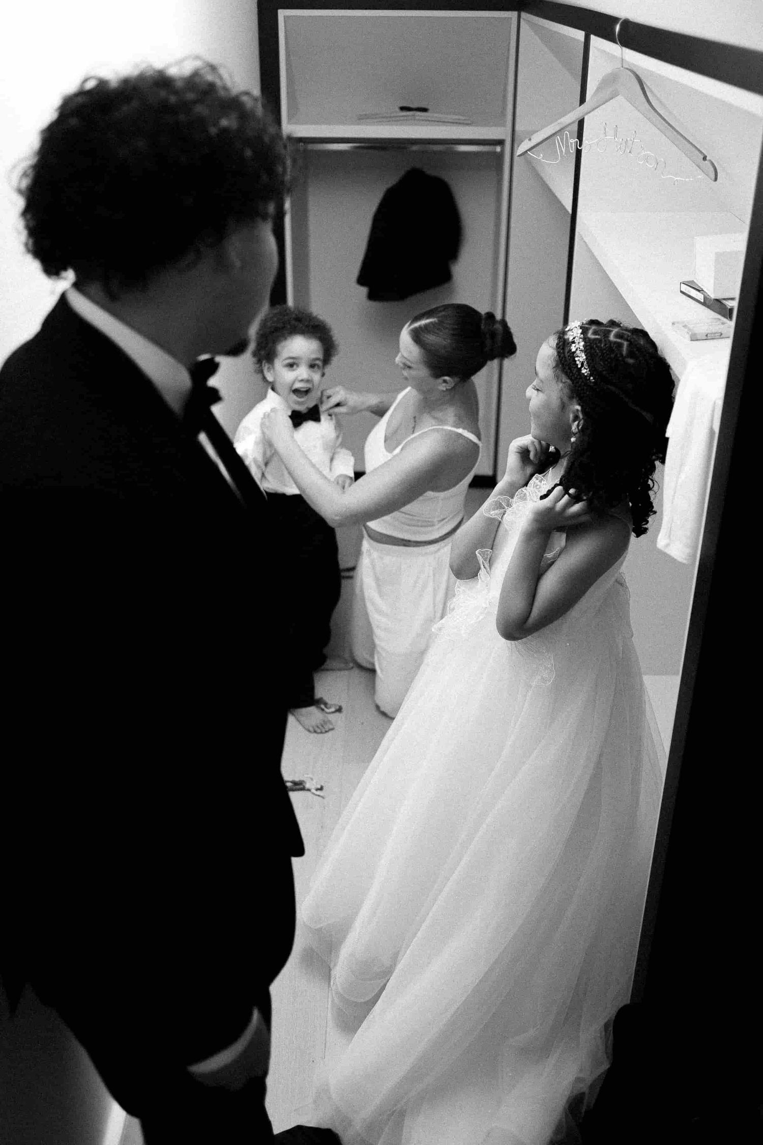 Family members helping one another prepare before the wedding ceremony.
