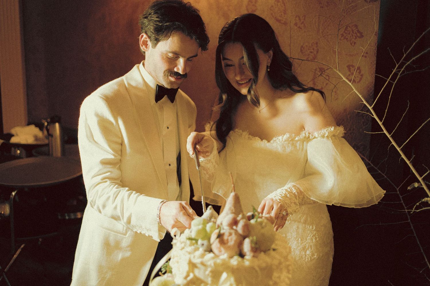 Bride and Groom cutting the cake at OOld Mill Toronto Fall wedding