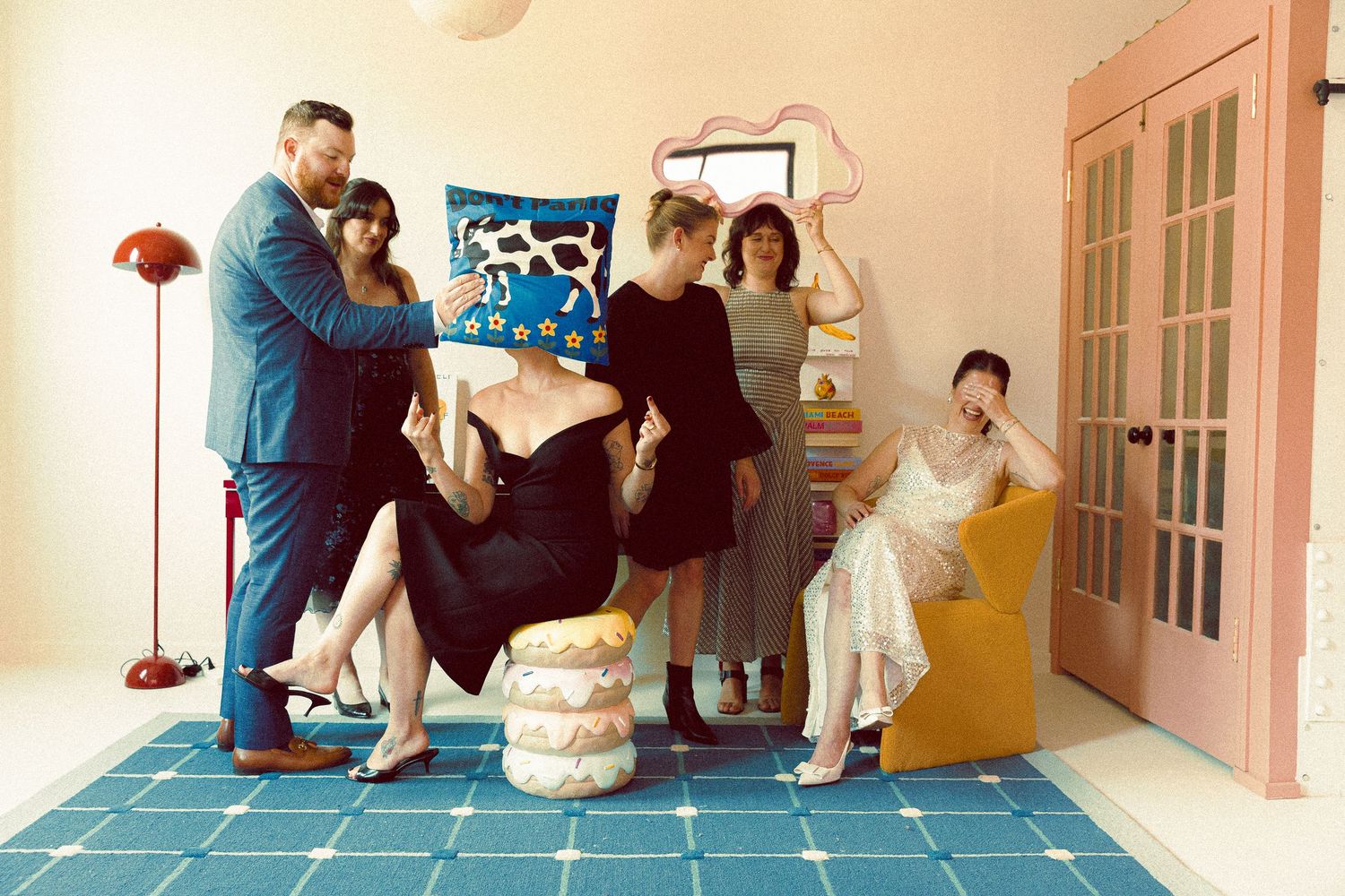 Playful wedding party photo in Toronto with the bride and bridespeople posing humorously, embracing a bold and non-traditional energy