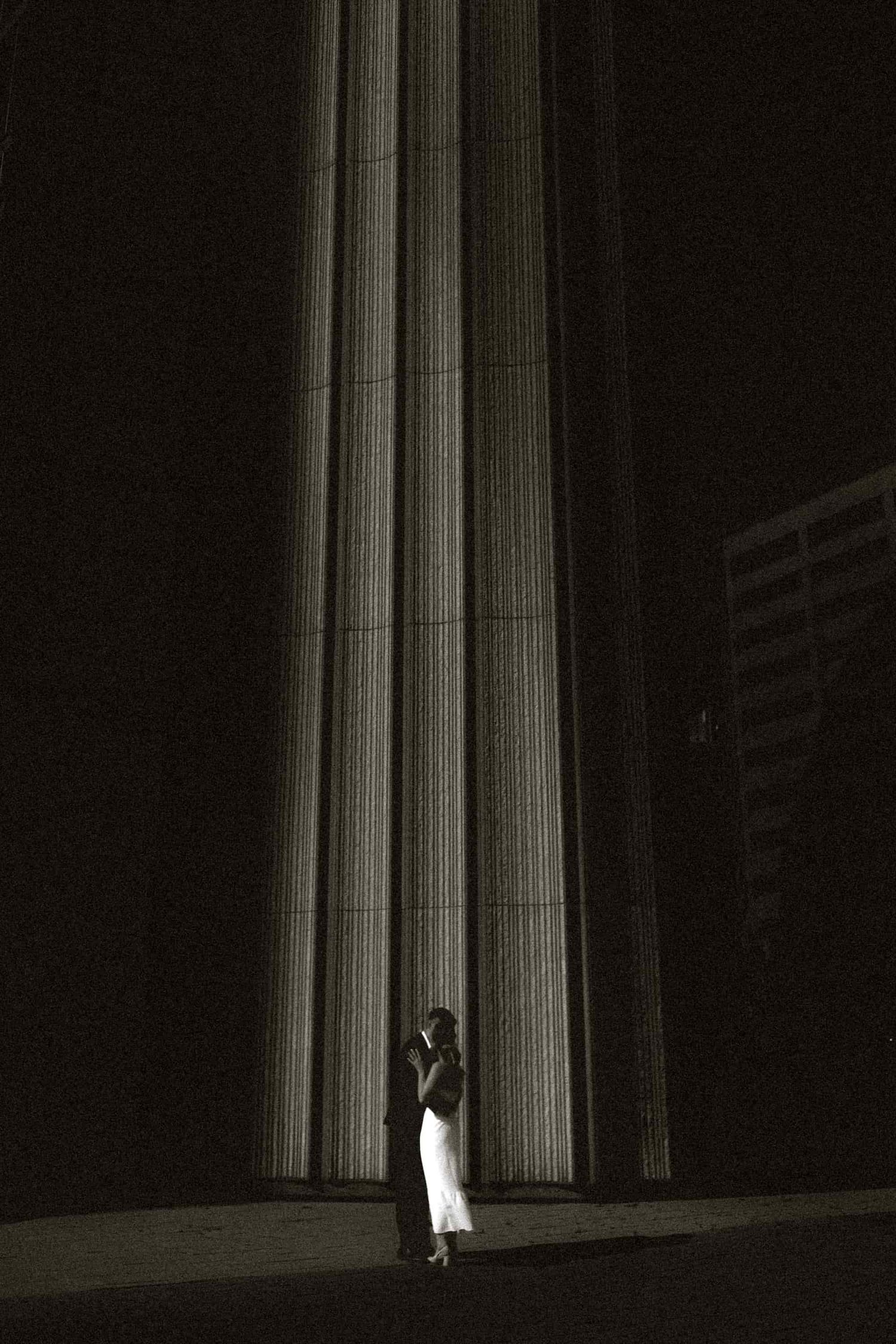 Dramatic black and white wedding portrait at Toronto City Hall with architectural column