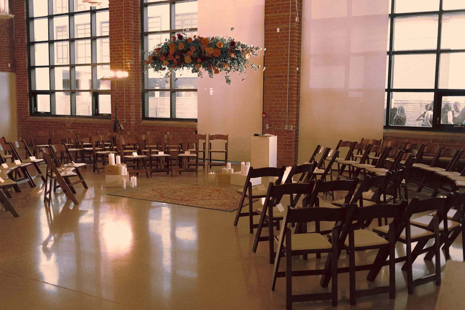 Ceremony altar decorated with flowers and candles before guests arrive.