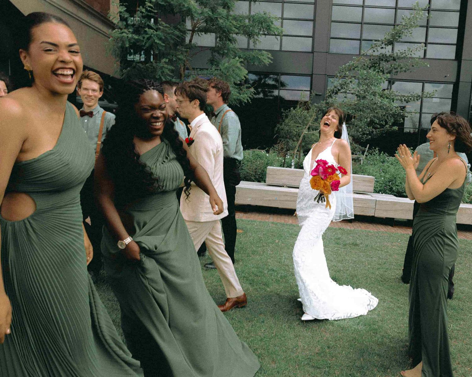 Couple and wedding party posing together near MOCA Toronto.
