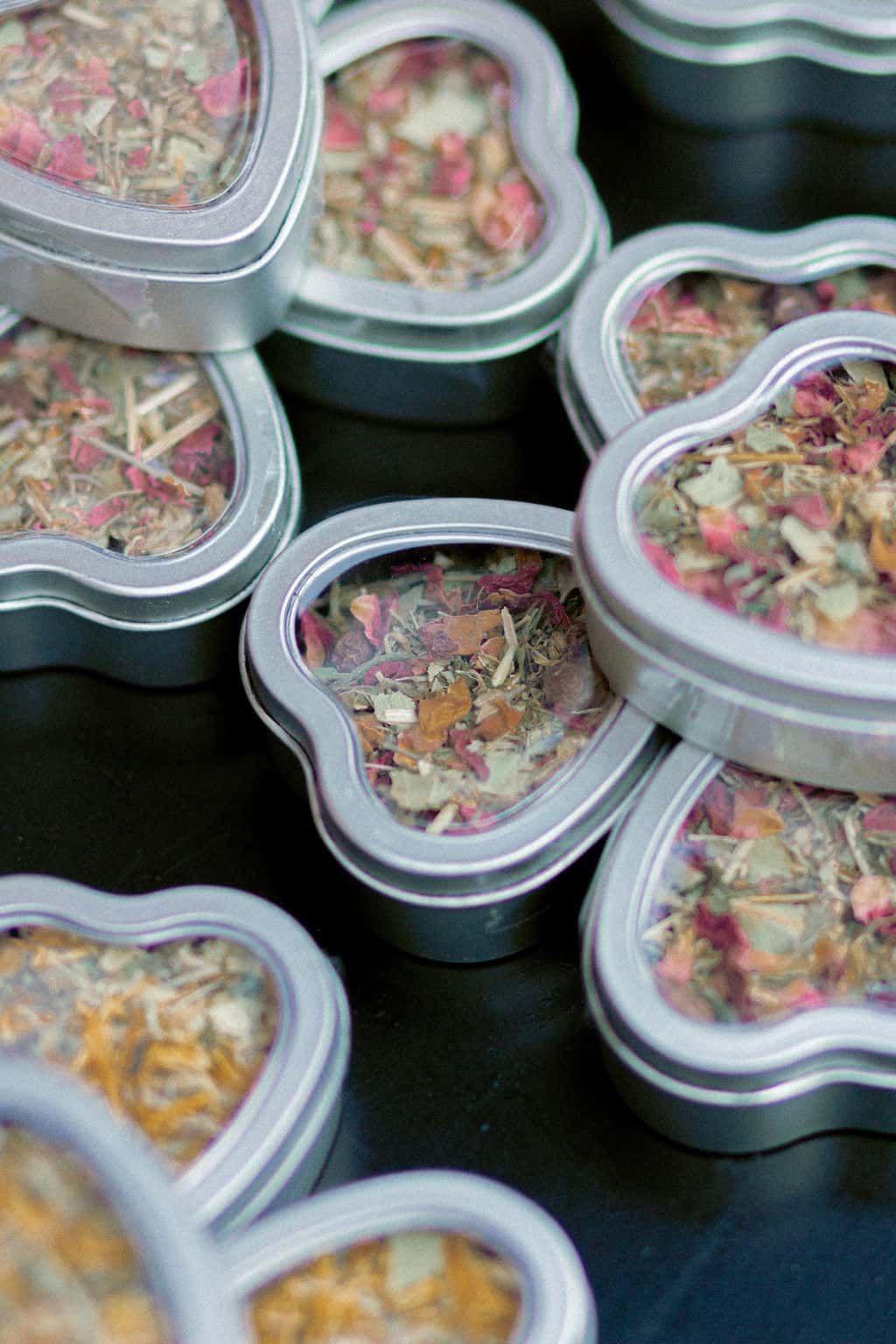 Handmade custom tea blend from Roncy Apothecary in heart shaped containers at queer commitment ceremony Bar Neon Toronto