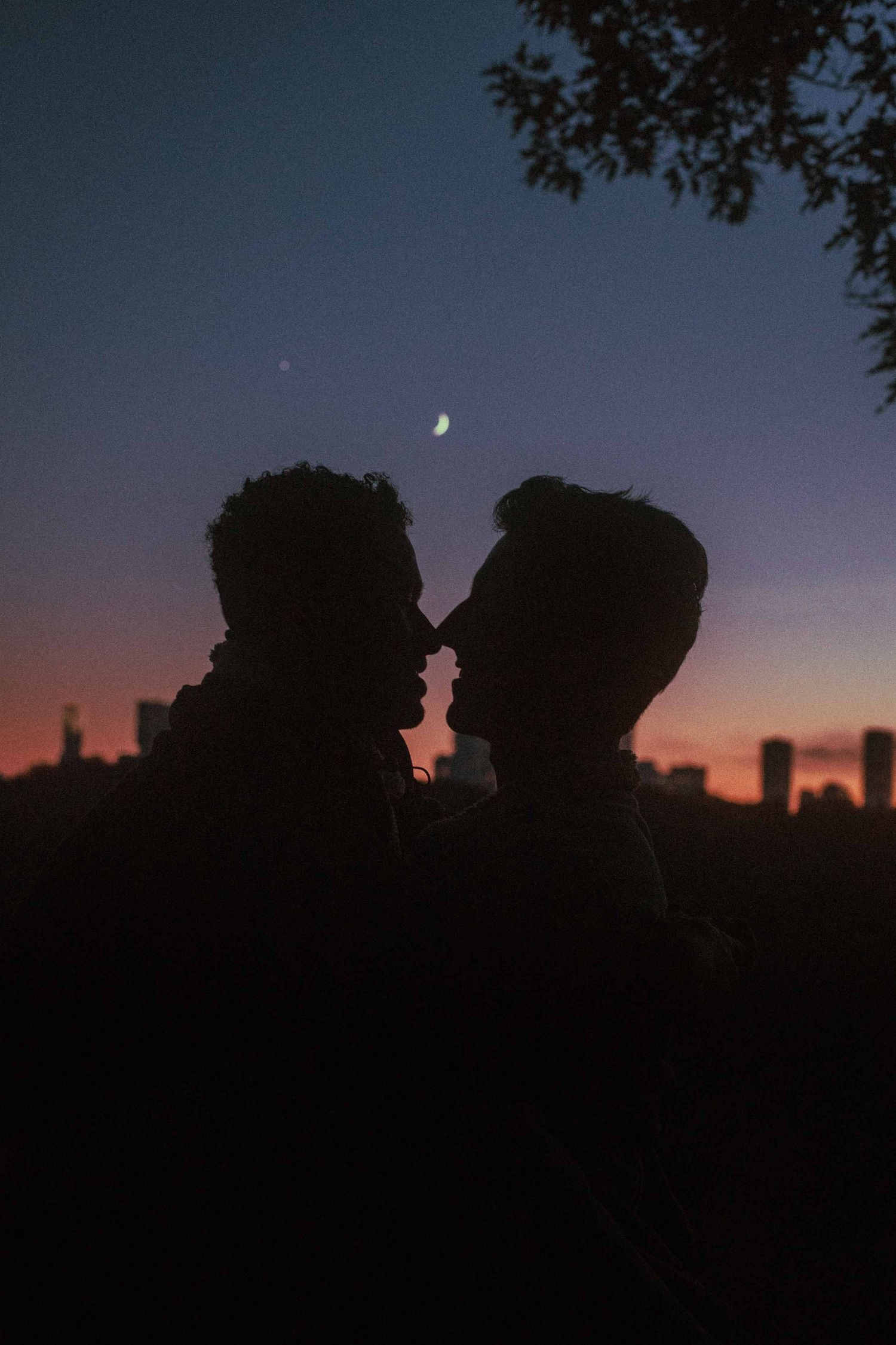 grom and grom kissing at night in front of Toronto skyline