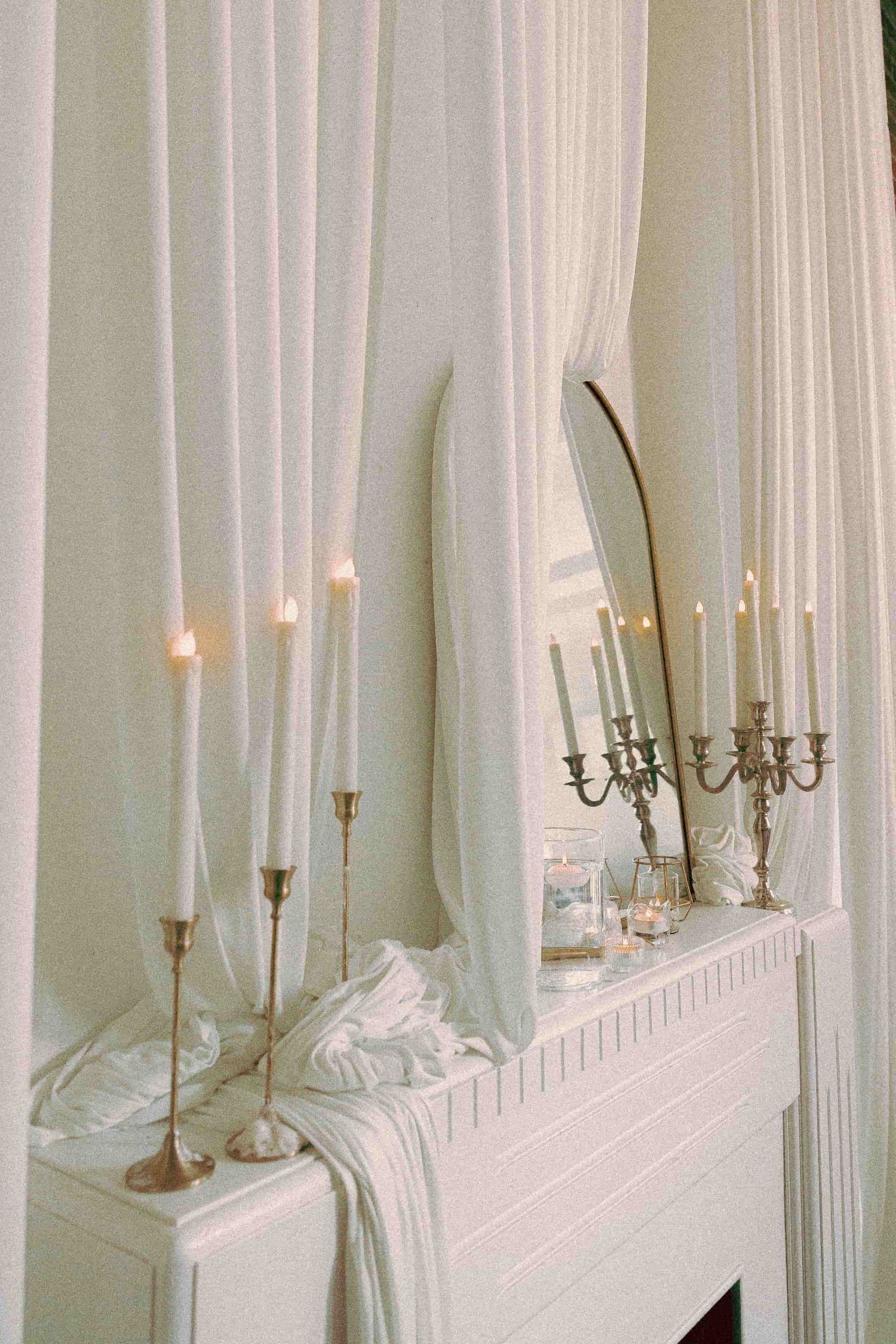 Reception tables set with flowers, candles, and place settings for guests.