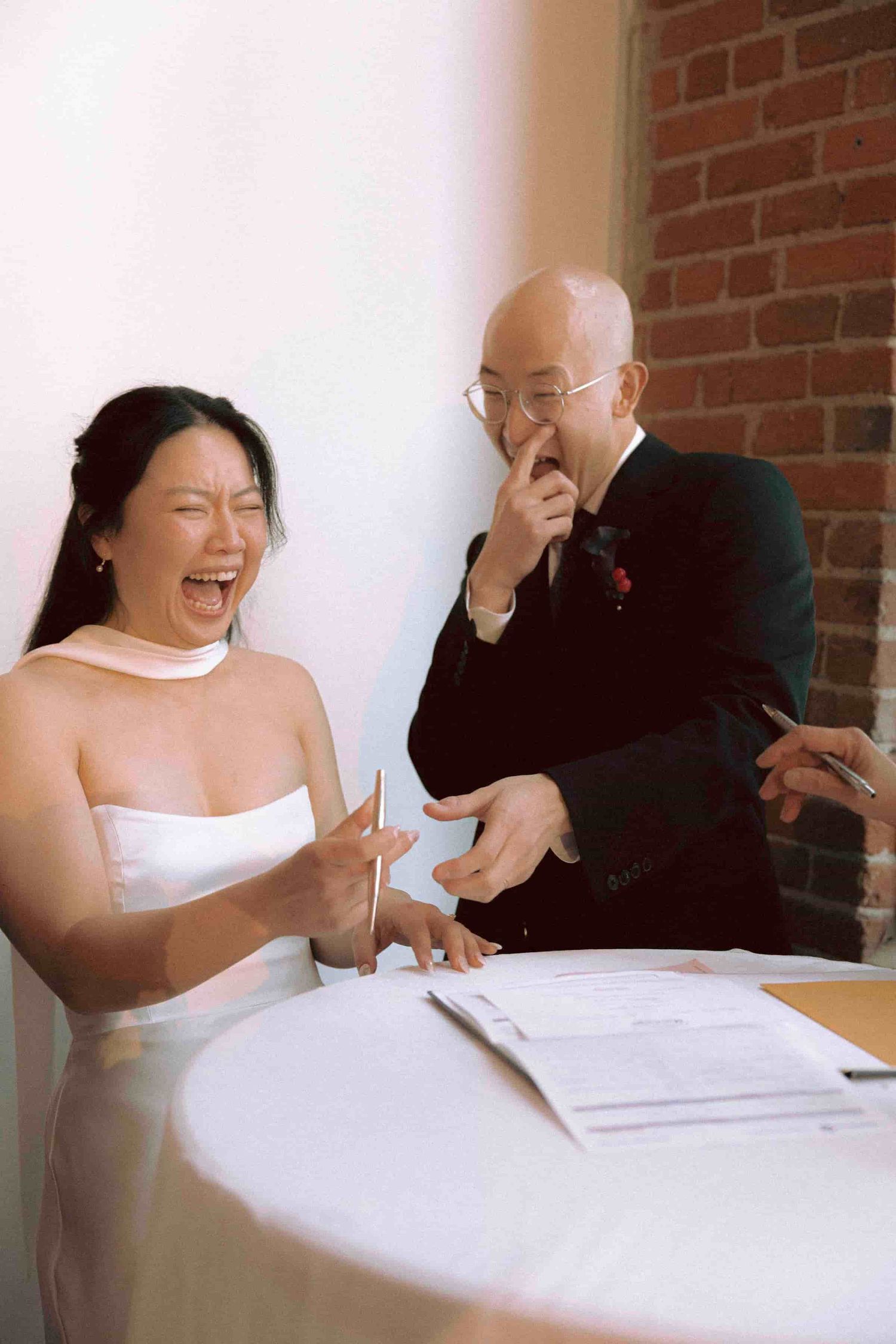 Couple signing their marriage license following their wedding ceremony at TCE on Sterling.