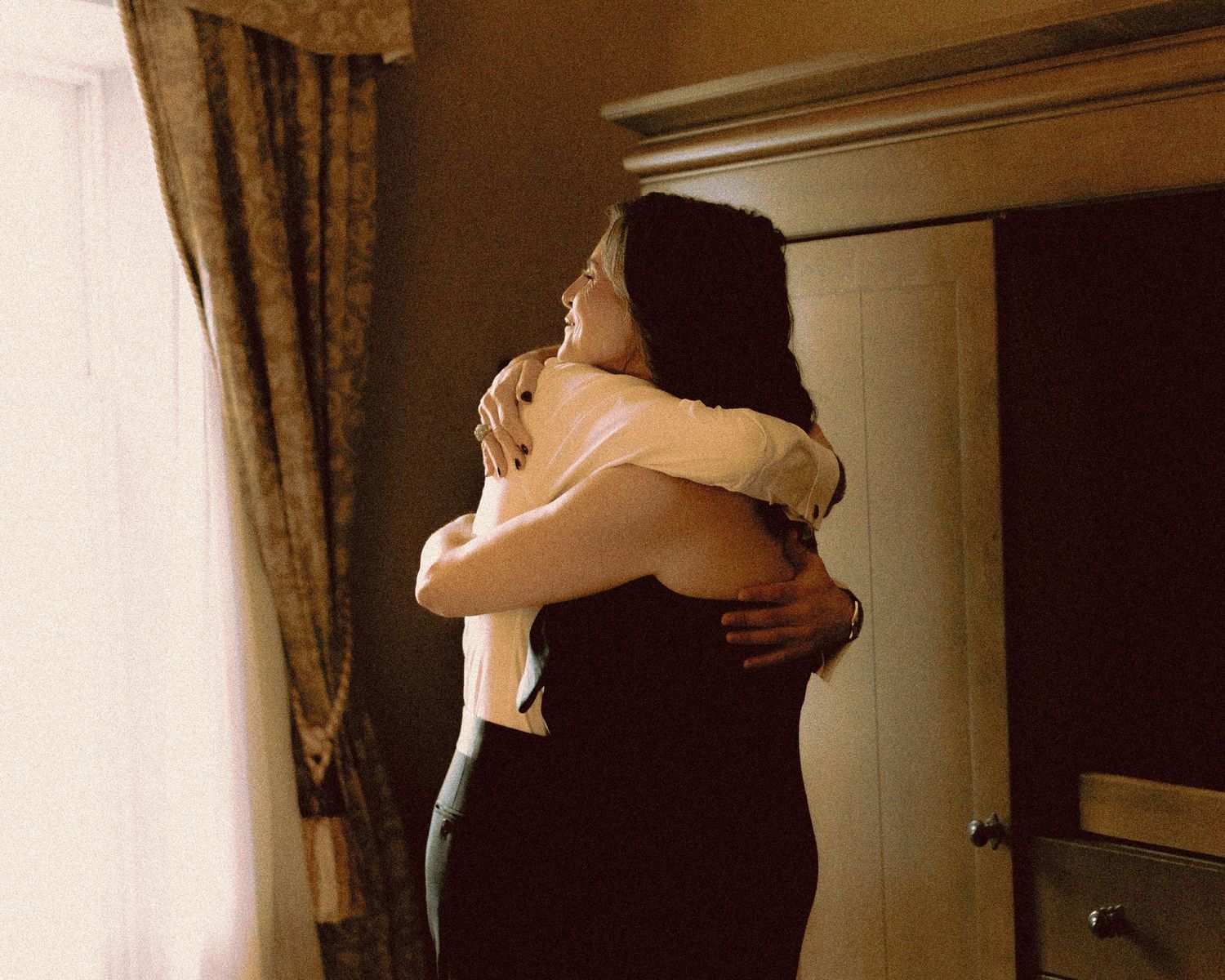jewish groom hugging mother  at Old Mill Toronto fall wedding