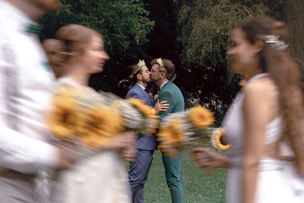 Wedding party carrying sunflowers during gay wedding ceremony at Fantasy Farm Toronto