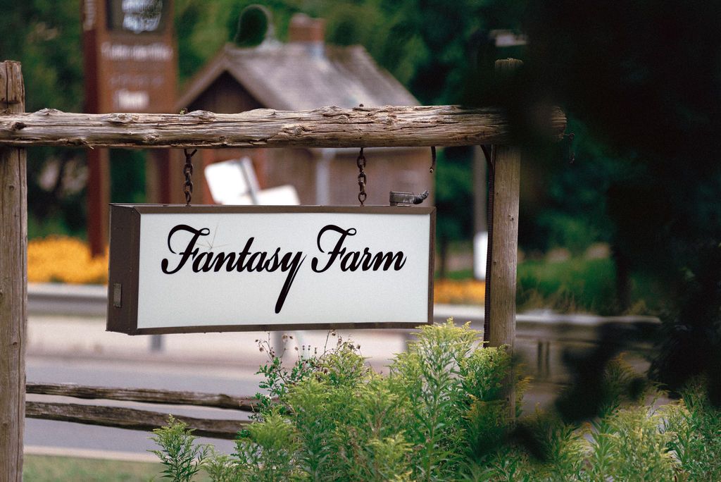 Outdoor garden ceremony surrounded by lush summer greenery at Fantasy Farm Toronto same-sex wedding