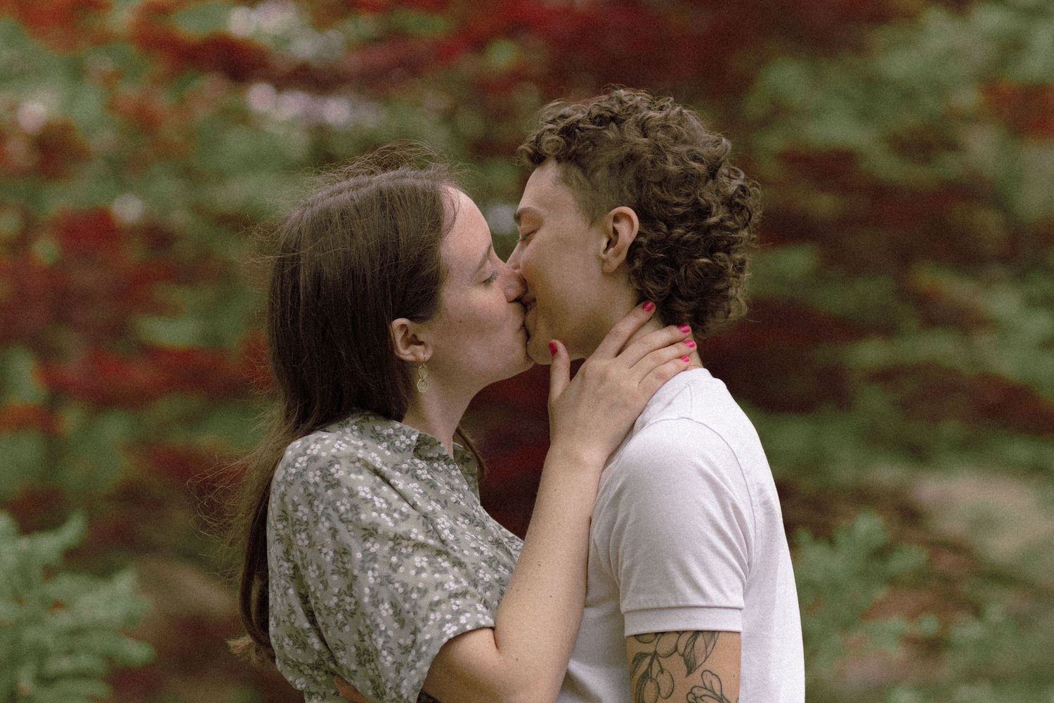 Spring engagement photos of a lesbian couple at High Park, surrounded by fresh greenery and soft light