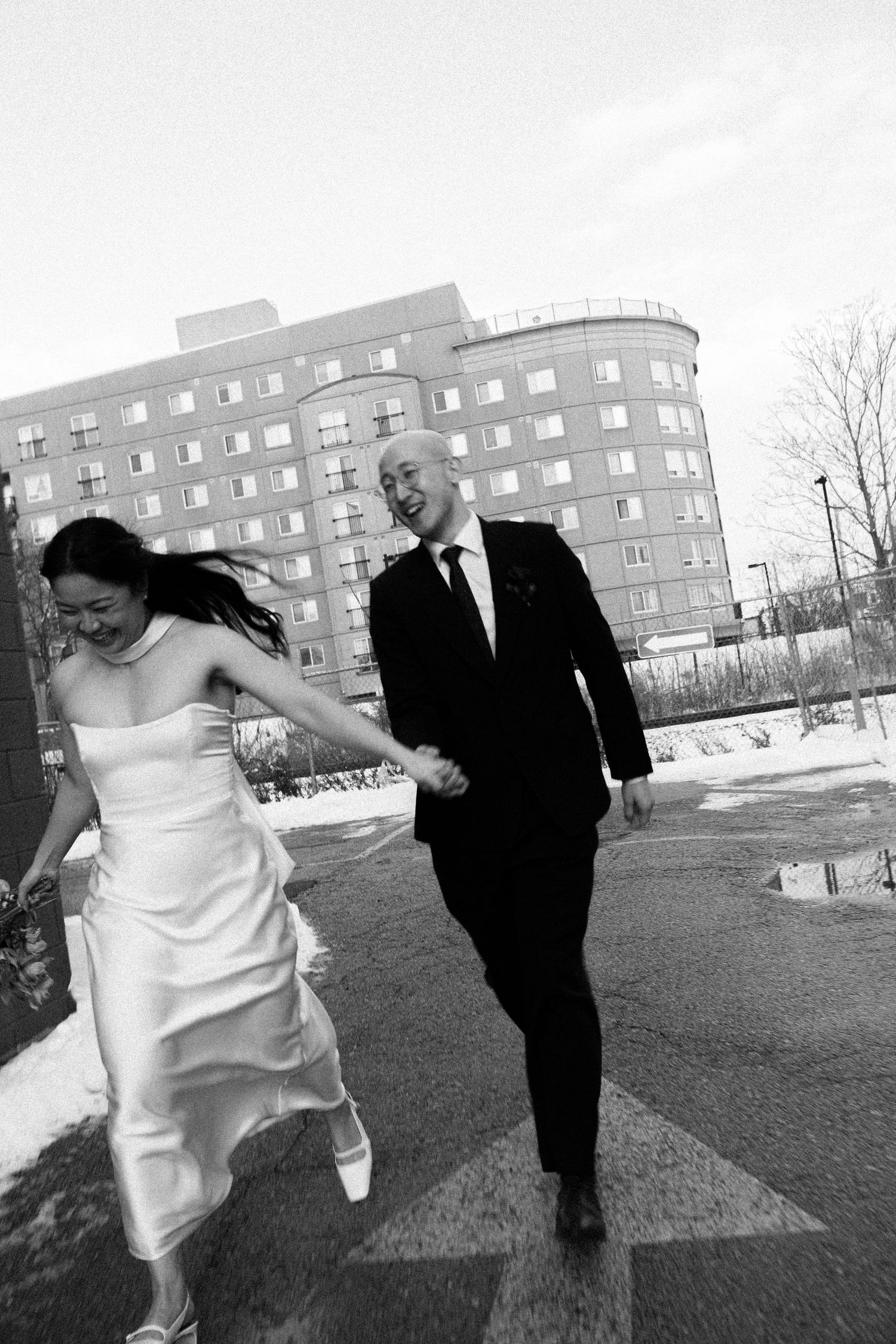 Candid wedding moment of a couple running outside Toronto Micro Weddings after their ceremony