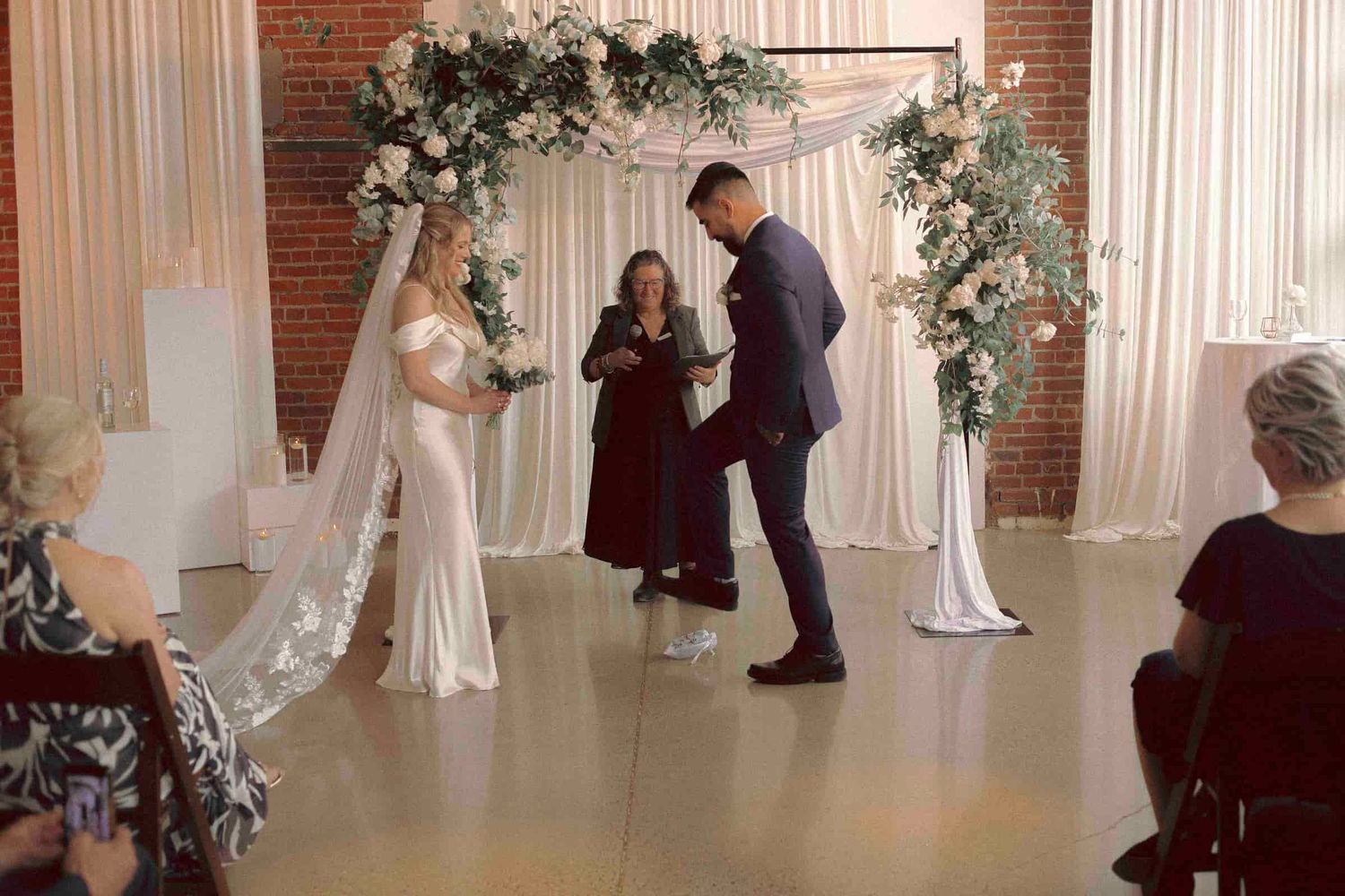 jewish groom stomping the glass before first kiss during wedding ceremony at Toronto micro weddings