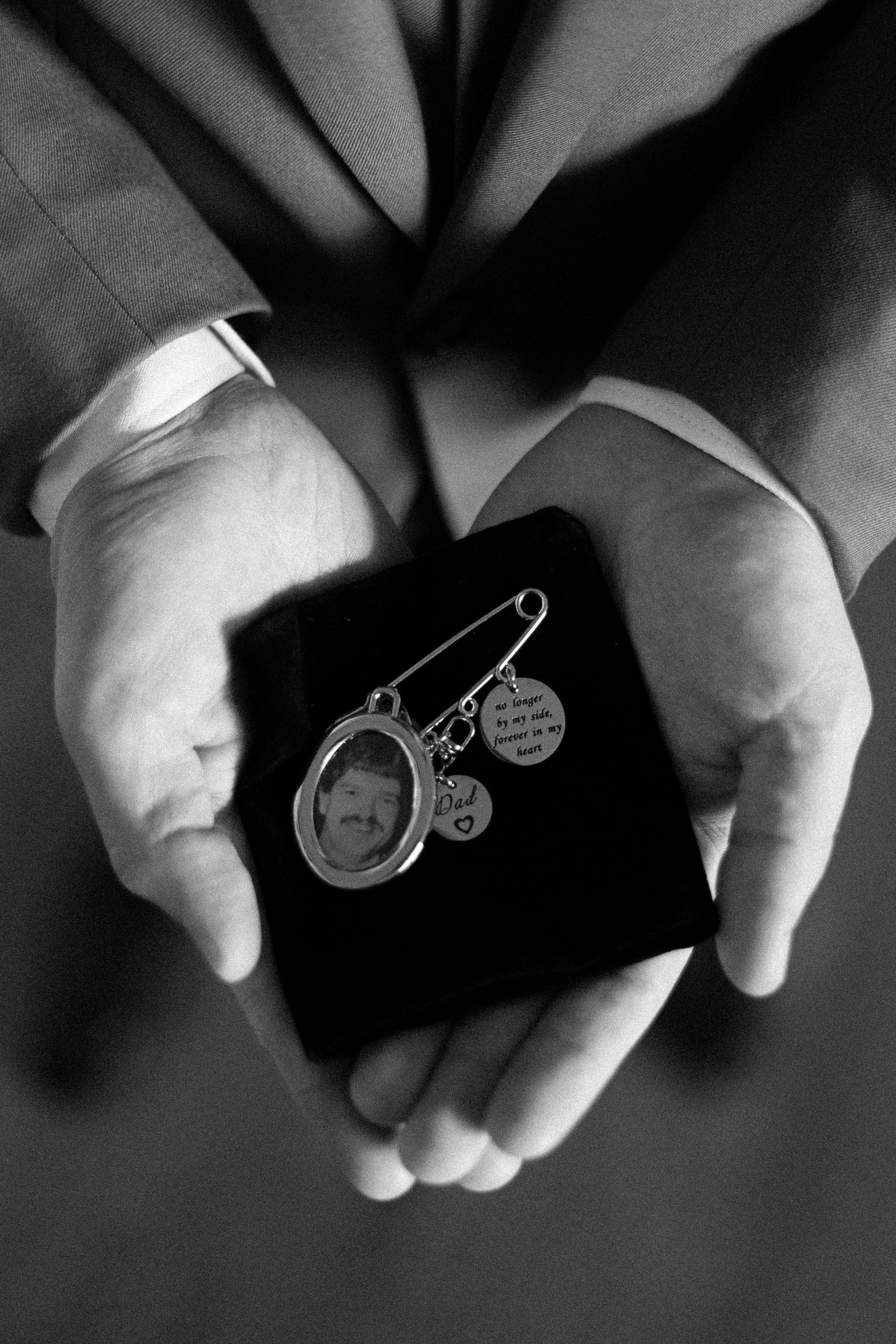 Close-up of sentimental boutonniere memorial pin, honouring a loved one during a Toronto wedding