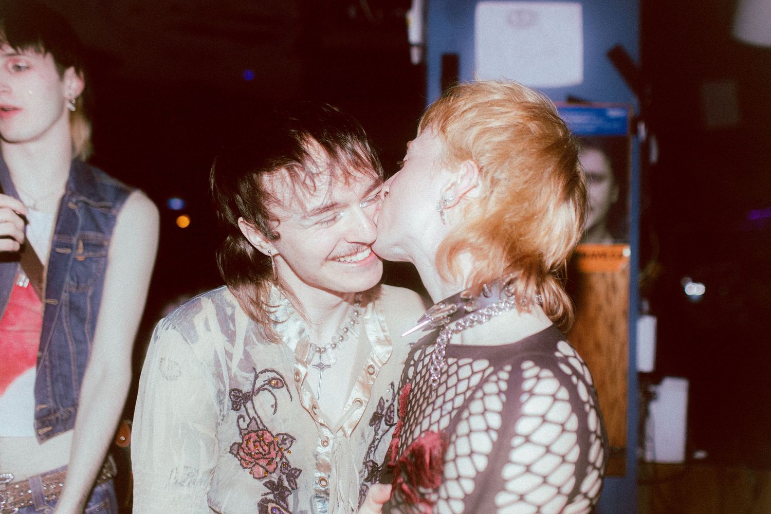 Queer couple kissing each other during Metamorphosis, a trans Pride party.