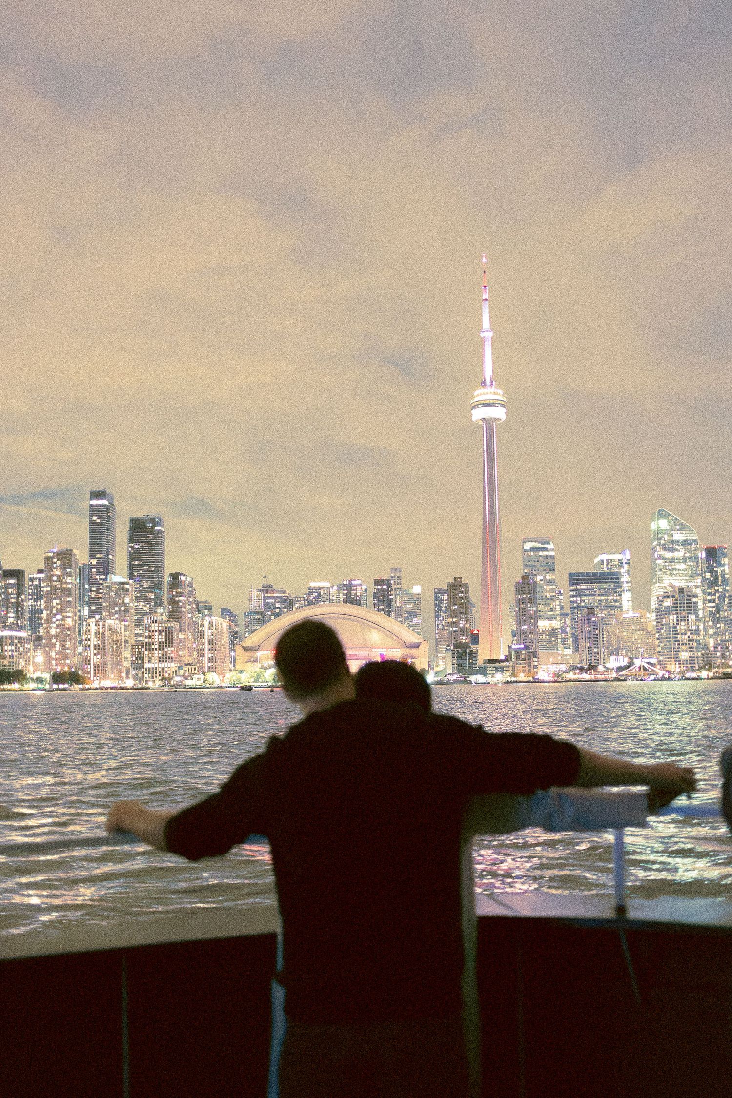 couple in front of CN tower after a wedding day on Toronto Island