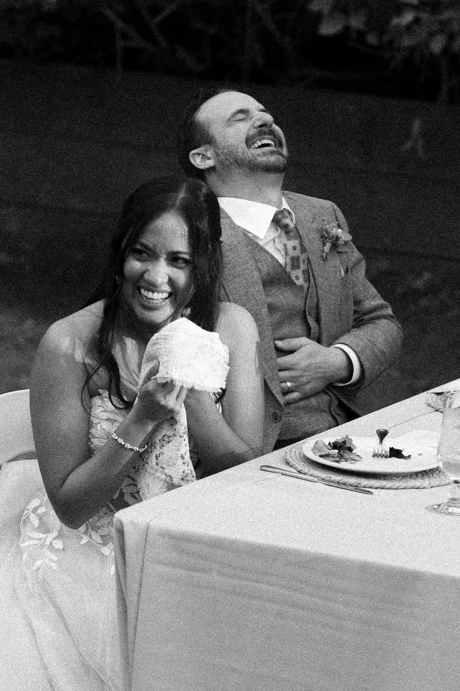 Bride and Groom laughing during dinner speeches on Toronto Island