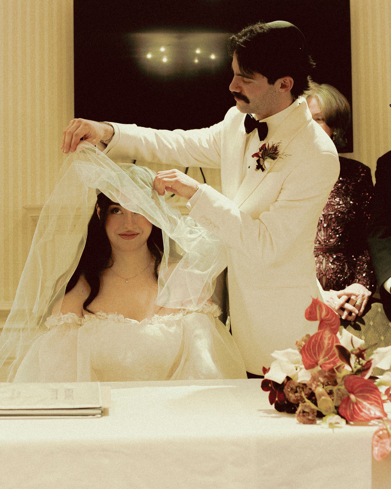 Groom covering bride during jewish bedeken ceremony at Old Mill Toronto fall wedding
