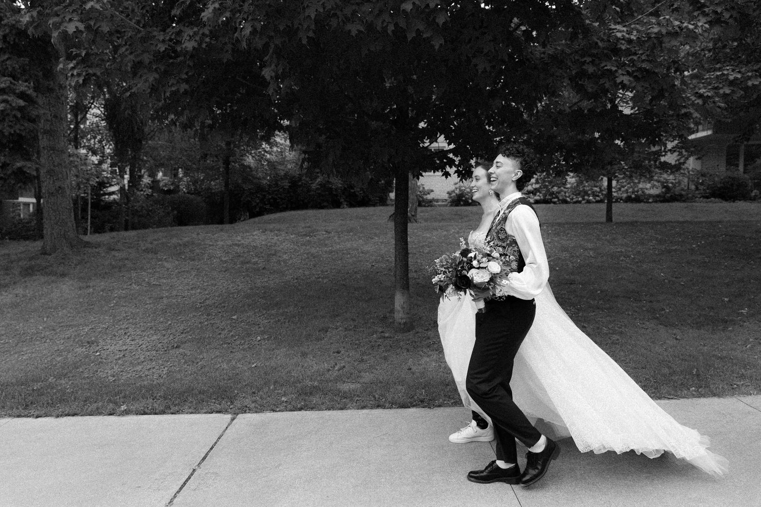 Lesbian couple walking towards their wedding at Granite Brewery Toronto