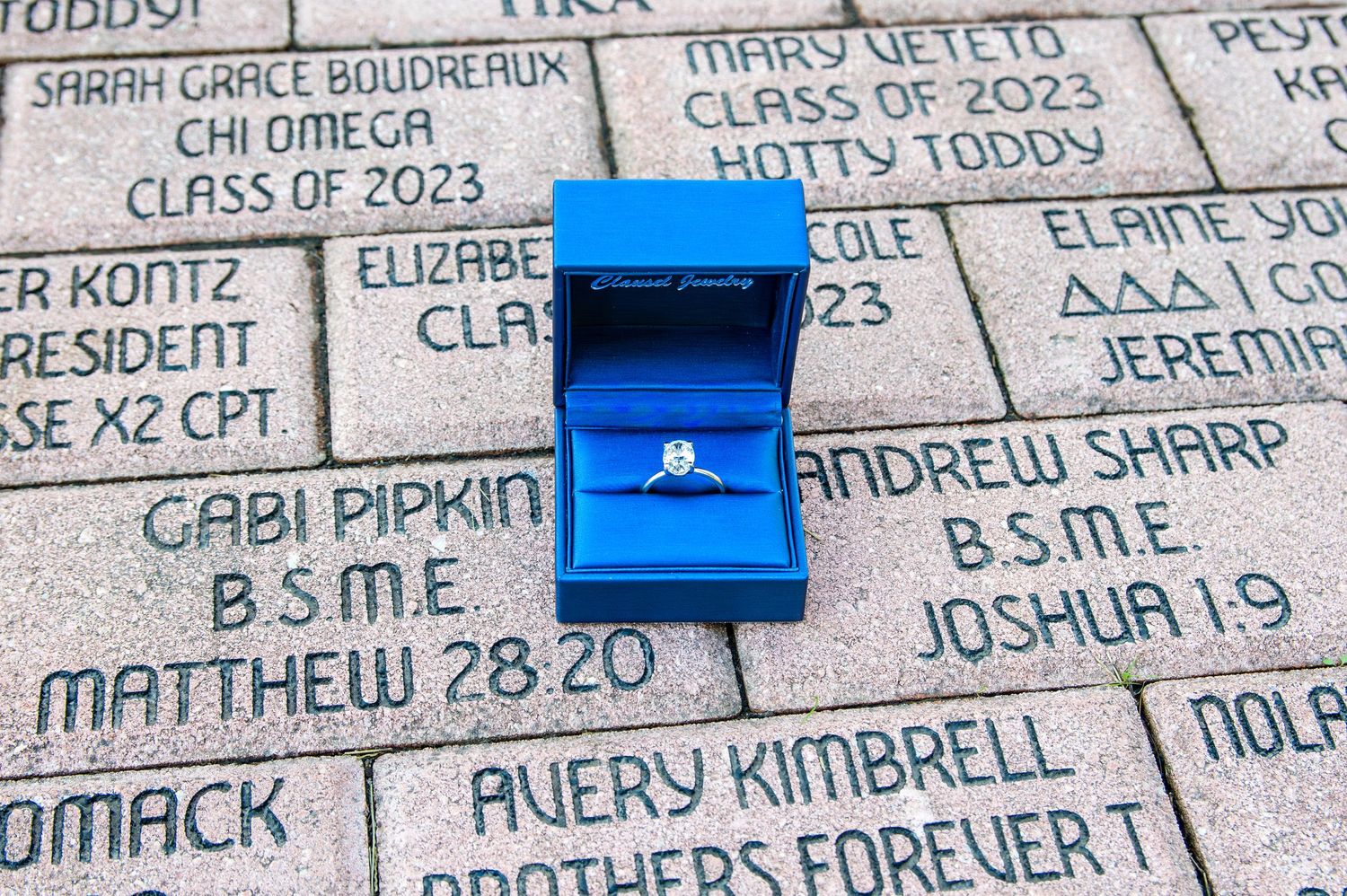Names handwritten in sharpie on glossy blue tiles create a personalized memorial wall display.
