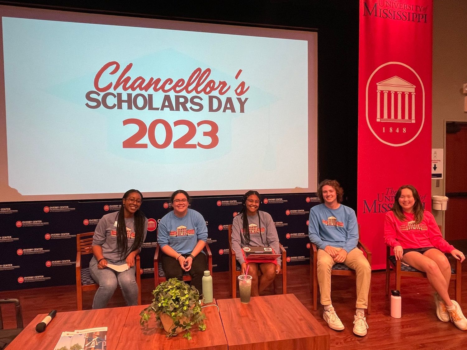 Five students sit on stage at University of Mississippi Chancellor's Scholars Day 2023 event.