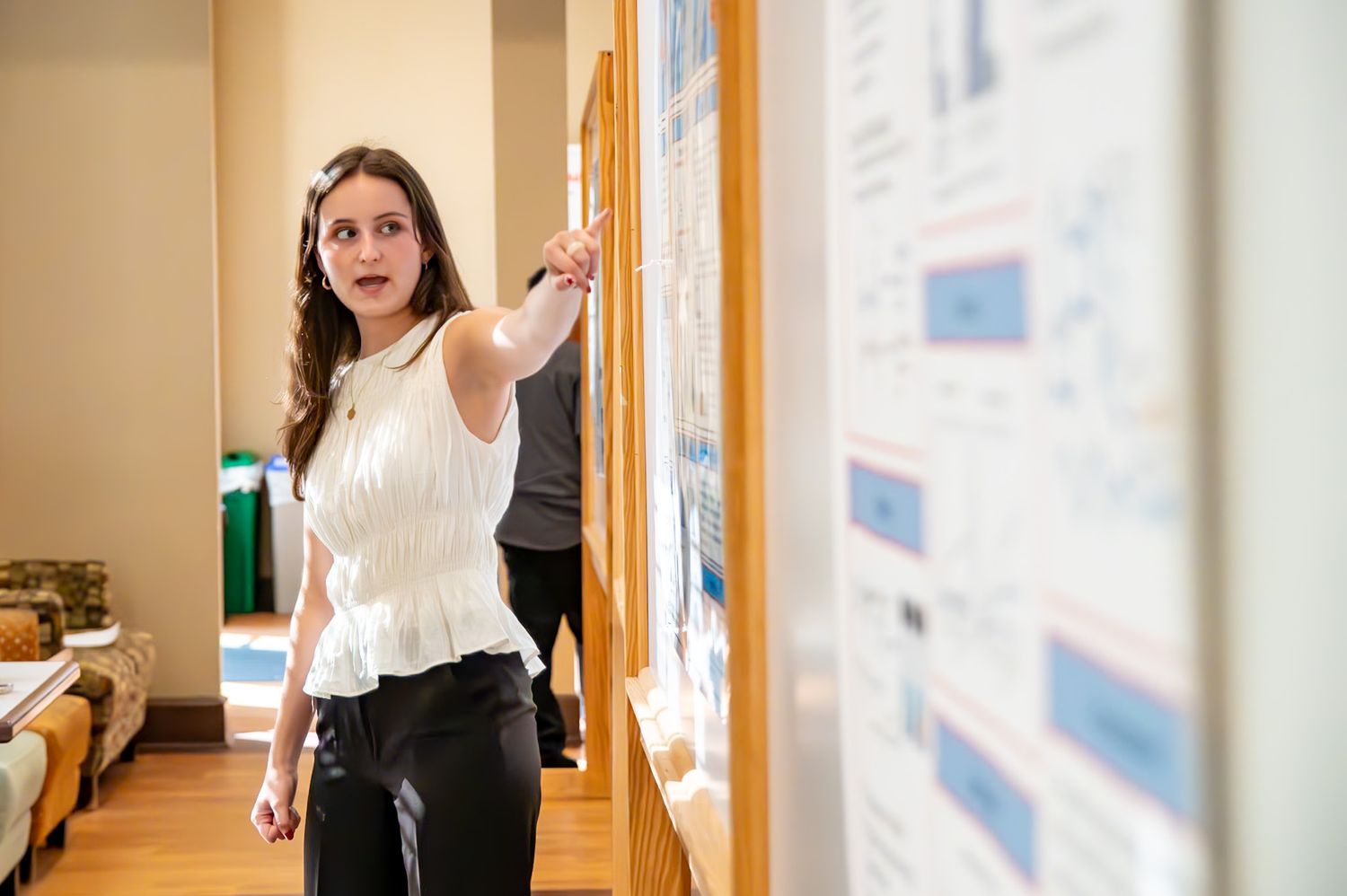 Colleagues engaged in discussion while walking through a modern office corridor.