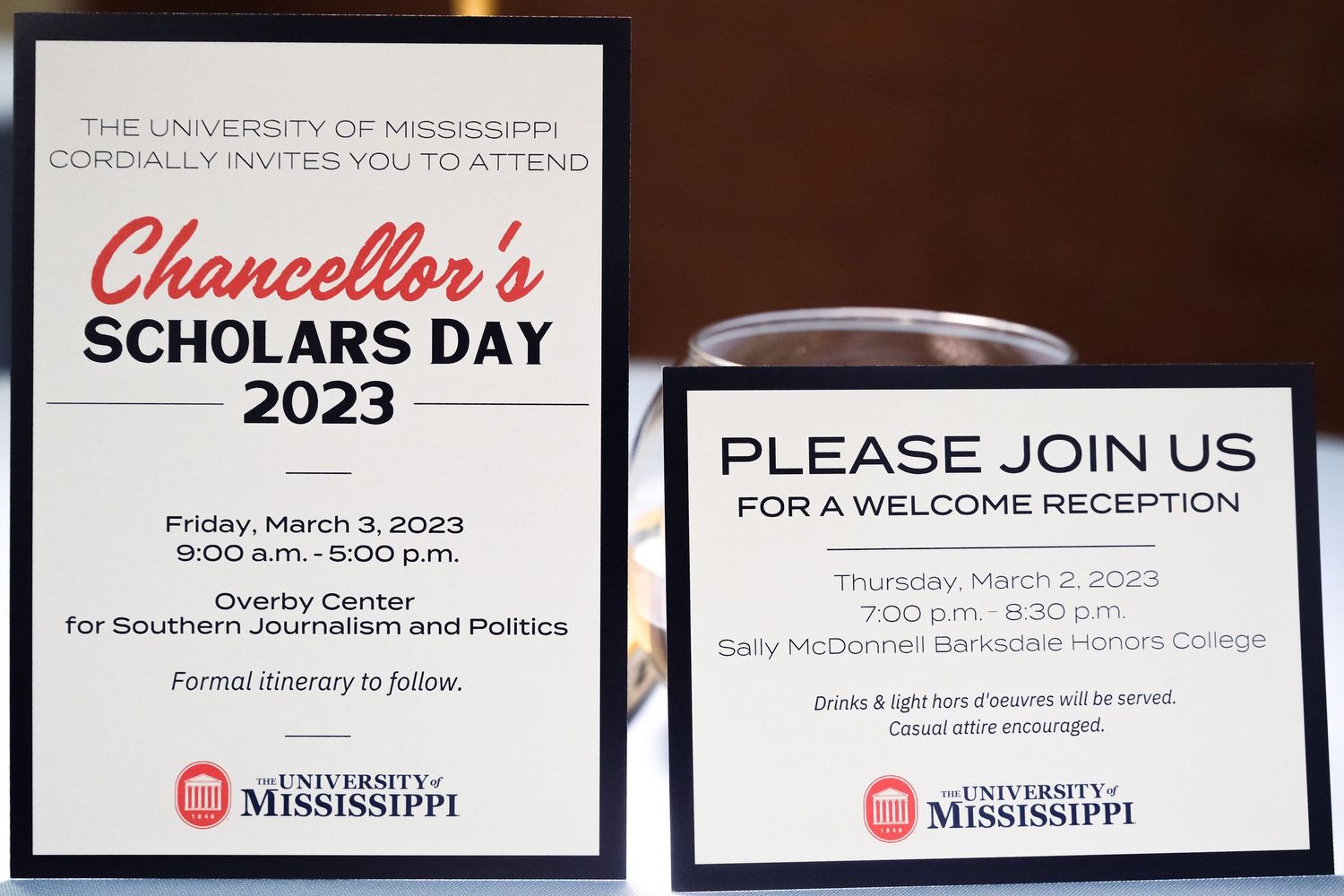 University of Mississippi Chancellor's Scholars Day 2023 and Welcome Reception invitation signs displayed at event.