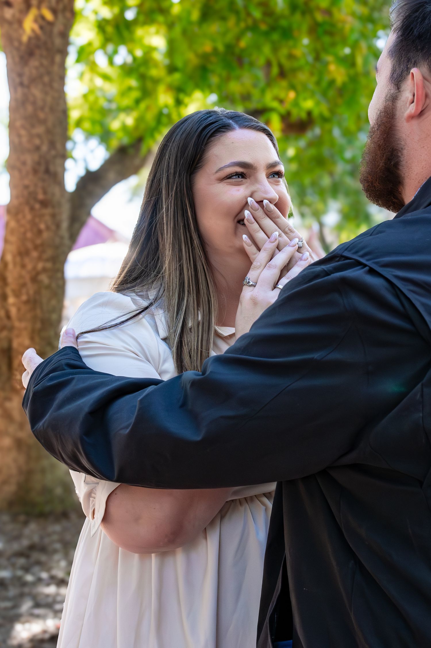 Sequence showing an emotional outdoor proposal captured in four candid moments among trees.